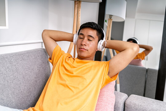 Young man relaxing listening to music at home
