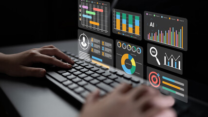 A person typing on a keyboard in a modern workspace, surrounded by vibrant data visualizations and analytics dashboards displayed on a transparent screen for enhanced productivity. Gantry