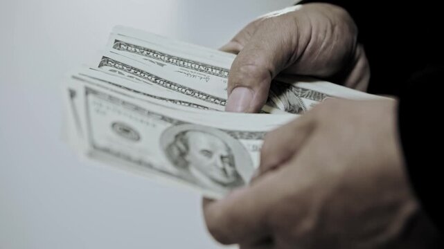 Counting cash in hands. Human hands counting paper money. Business finance theme. Budget planning, income control and cash flow management.