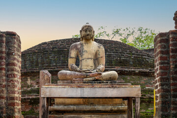 Ancient Buddha Statue Amidst Historic Polonnaruwa Temple Ruins