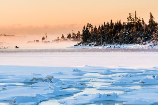 morning fog over frozen ocean bay
