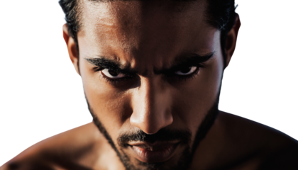 Close-up portrait of a man with an intense, determined gaze in dramatic lighting