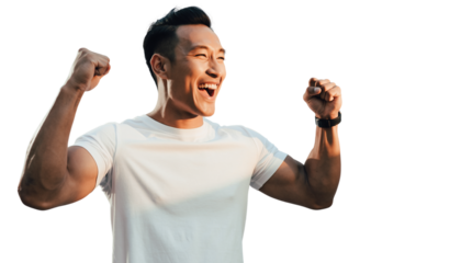 Happy young man cheering with fists raised, celebrating success and achievement outdoors.