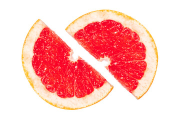 A slice of grapefruit is cut in half, revealing its juicy red interior