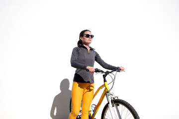 sporty woman with yellow bicycle outdoors
