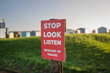 stop look listen beware of trains sign