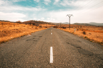 A long, empty road with a white line down the middle