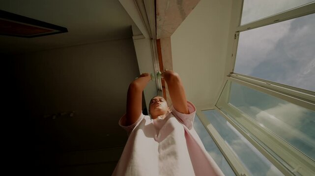 Dynamic exercise with small weights shown through window shot
