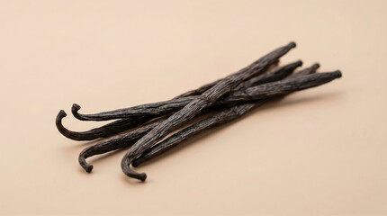 Dried vanilla beans arranged on a soft beige background