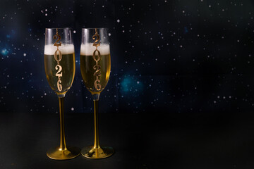 New Year's Champagne Celebration. Two champagne glasses with 2026 design