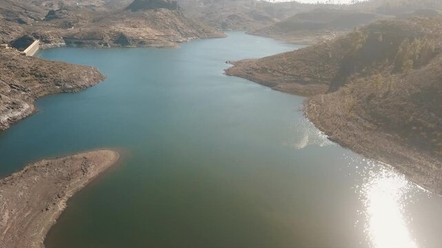 Aerial shot of the Presa de Las Ninas reservoir in Gran Canaria, surrounded by mountains