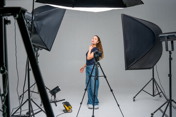 Influencer poses for content creation in a studio with lights and cameras