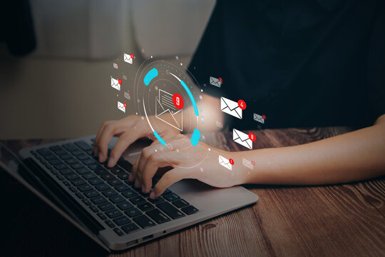 Email notification overload concept. Person typing on laptop with floating message icons, digital communication stress, inbox management, productivity challenge, online work pressure.