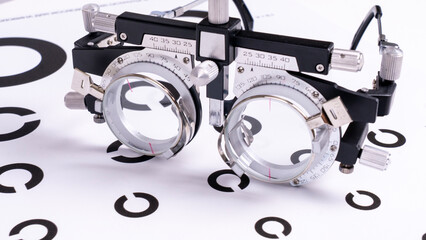 Eye astigmatism, vision health check with an optometrist. Trial frame for optical lens detection....