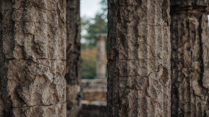 Fototapeta premium Ancient stone columns with detailed textures and weathered surfaces in a historical archaeological site.