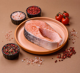 Fish, raw salmon steak, fresh seafood for grilling with salt, spices, and herbs. Raw salmon steak