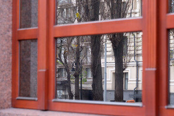 Urban reflections dance in window pane during quiet afternoon