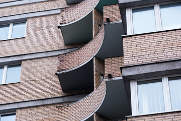 Curved balcony design on a modern building in a vibrant cityscape