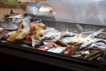 Freshly prepared fish displayed in a vibrant market stall