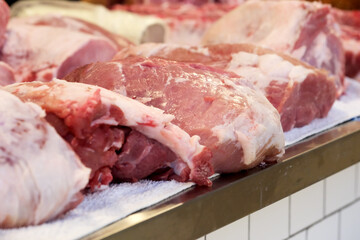Fresh cuts of meat displayed at a vibrant local market