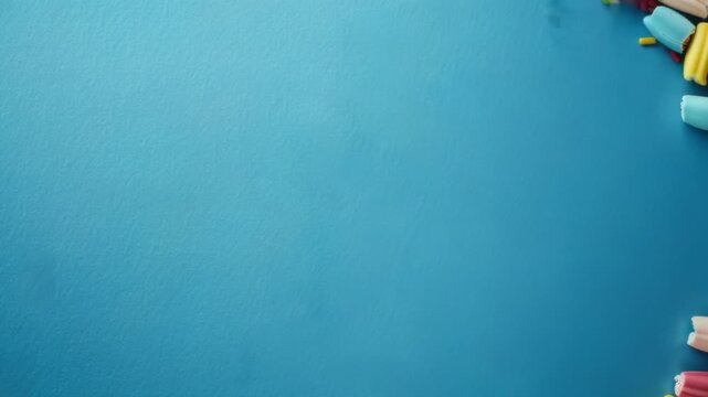 Video A pile of colorful candies on a blue surface, perfect for use in ads or social media posts
