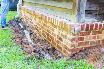 Termite treatment on the foundation of a house.