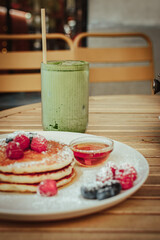 Matcha coffee pancakes, fruits and syrup