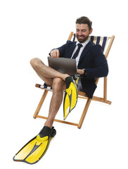Businessman with laptop and flippers in deck chair on white background © New Africa