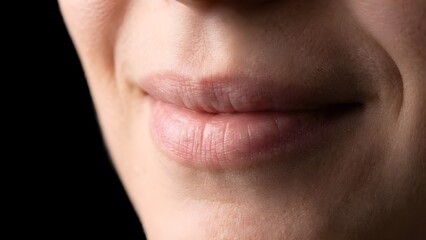Obraz premium Extreme close-up macro of a woman smiling, showing natural teeth and soft skin texture. Realistic lighting, shallow depth of field, professional macro photography, clean and minimal composition. (9)