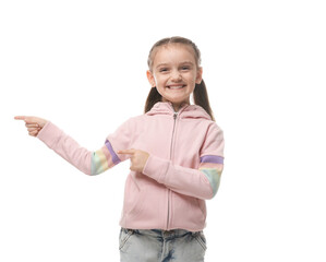 Smiling little girl with pigtails pointing at something on white background