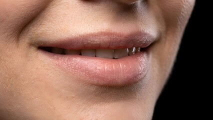 Fototapeta premium Extreme close-up macro of a woman smiling, showing natural teeth and soft skin texture. Realistic lighting, shallow depth of field, professional macro photography, clean and minimal composition. (9)