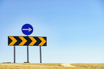 Signs with arrows on road