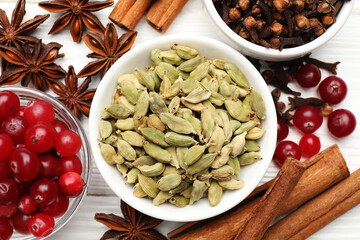 Different spices and cranberries for mulled wine on white table, flat lay