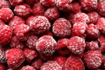 Frozen ripe raspberries as background, above view