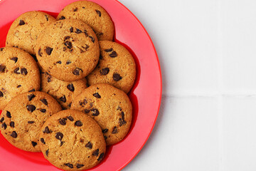 Delicious chocolate chip cookies on light table, closeup. Space for text