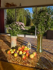 Autumn apples  and flowers on veranda