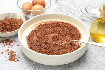 Chocolate dough and ingredients on grey textured table, closeup
