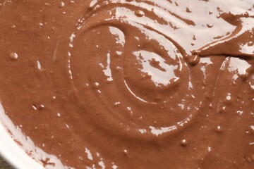 Texture of liquid chocolate dough as background, top view