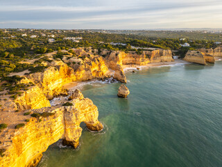 Marinha Beach, Arch, Sea Stacks, Cliffs and Atlantic Ocean on Sunny Morning. Aerial Drone Shot. Algarve, Portugal