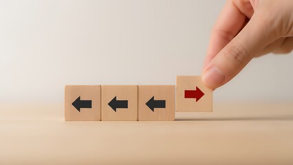 Uniqueness concept with red arrow changing direction on wooden cubes