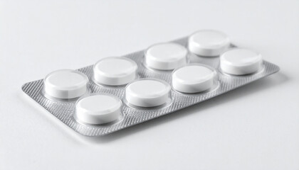 Blister pack of round white pills lying on plain white surface, minimalistic pharmaceutical product