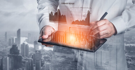 A business professional analyzes data on a digital tablet, showcasing graphs and charts in a modern urban setting. The image reflects finance and technology integration. Impute