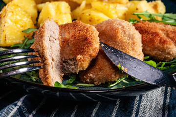 Meatballs with cheese served with boiled potatoes.