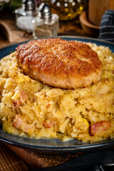 Minced meat cutlet with boiled sauerkraut.