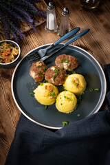 Meatballs with cheese served with boiled potatoes.