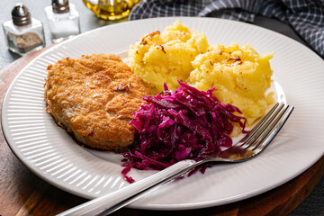 Minced meat cutlet served with mashed potatoes and salad.