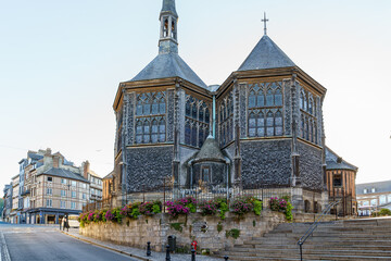 An ancient wooden church Eglise sainte Catherine with 2 buildings in Honfleur Normandy France. The photo was taken in the evening