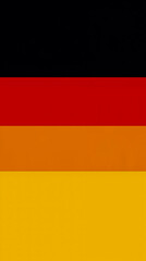 A vertical striped flag with alternating colors of red orange yellow and black