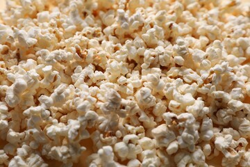 Fresh tasty popcorn as background, closeup view