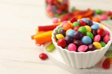 Delicious colorful candies on white table, closeup. Space for text